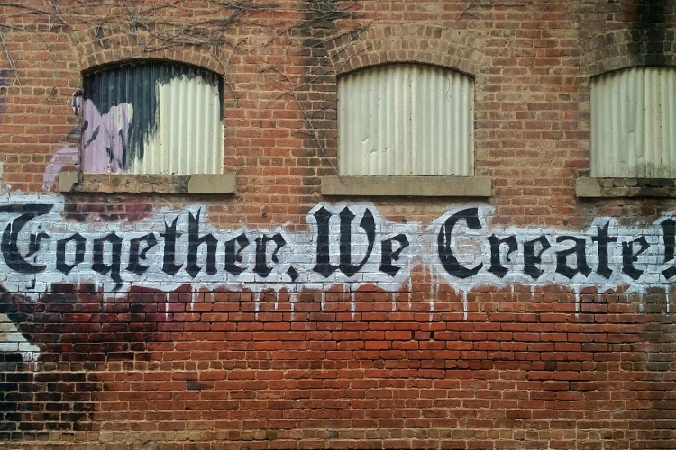 “Together, we create!” on brick wall, bamagal, Unsplash